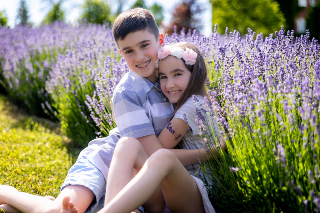 Siblings posing during a lavender field photo shoot.