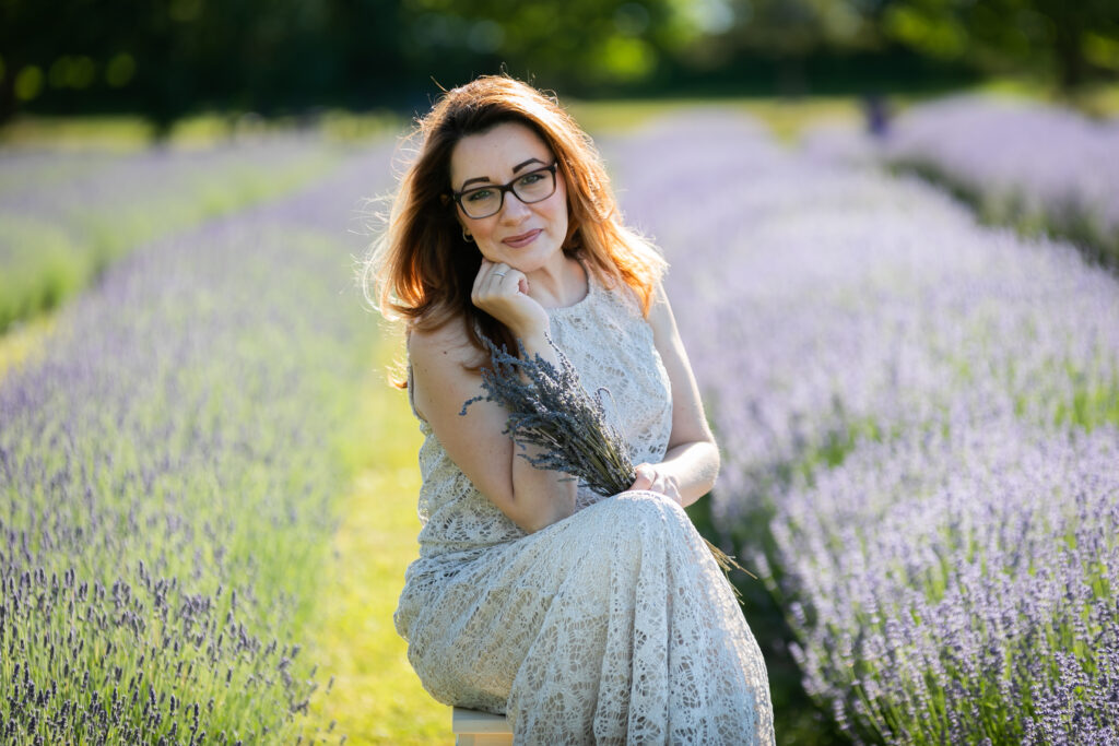 Woman in her 40s posing during lavender field photography.