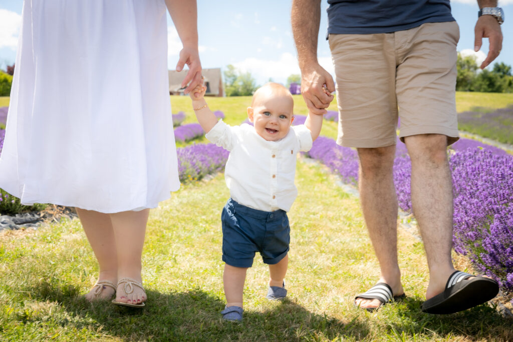 Parents and baby captured in a lavender field photo shoot